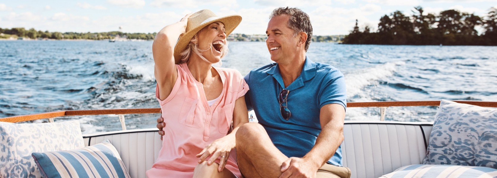 Elderly couple in a speedboat on a lake in Ontario's cottage country.